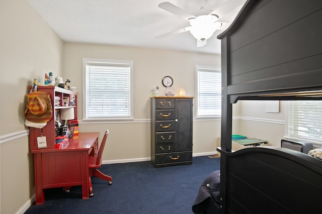 bedroom featuring dark colored carpet, multiple windows, and ceiling fan