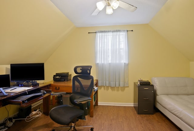 office area featuring hardwood / wood-style floors, vaulted ceiling, and ceiling fan