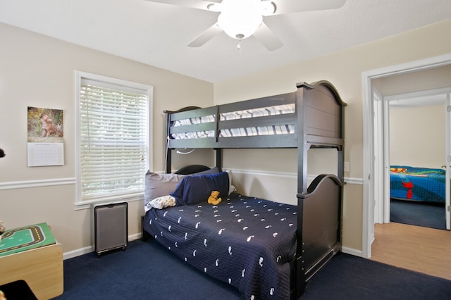 bedroom with dark carpet and ceiling fan