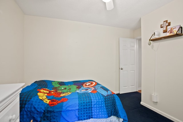 carpeted bedroom with a textured ceiling and ceiling fan