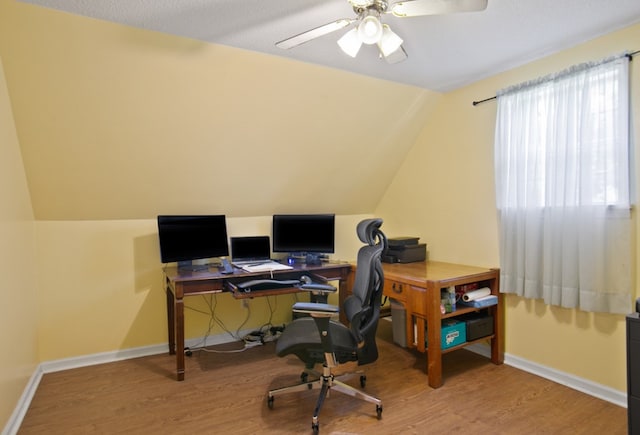 office area featuring lofted ceiling, wood-type flooring, and ceiling fan