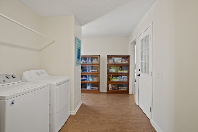 washroom with hardwood / wood-style floors, a textured ceiling, and separate washer and dryer