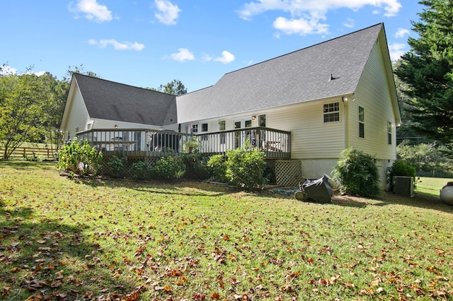 back of house featuring a deck and a lawn