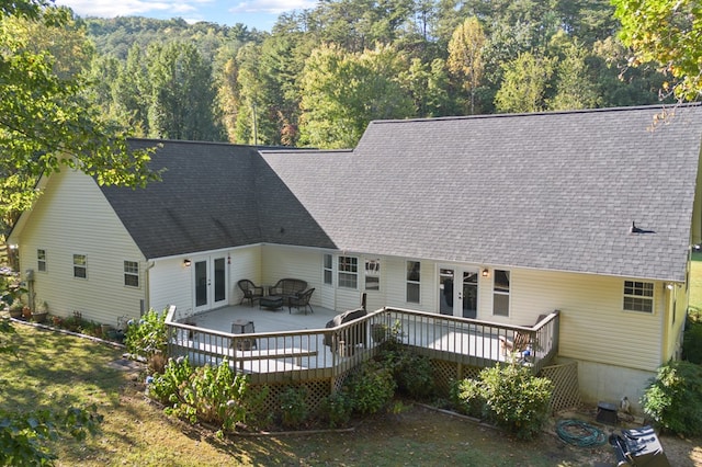 rear view of house featuring french doors and a deck