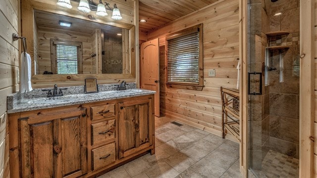 bathroom with wooden ceiling, wood walls, a shower with door, and vanity