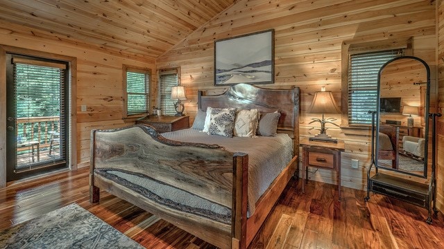 bedroom with wood ceiling, wood-type flooring, lofted ceiling, wood walls, and access to outside