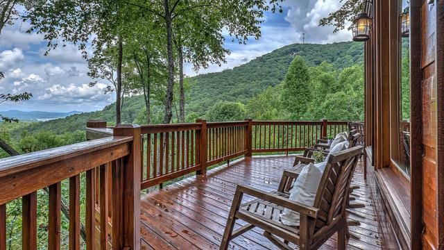 wooden deck with a mountain view