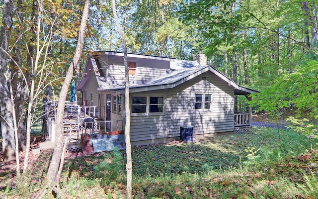 view of home's exterior with a wooden deck