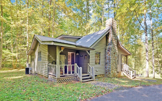 view of front of house with a porch and cooling unit