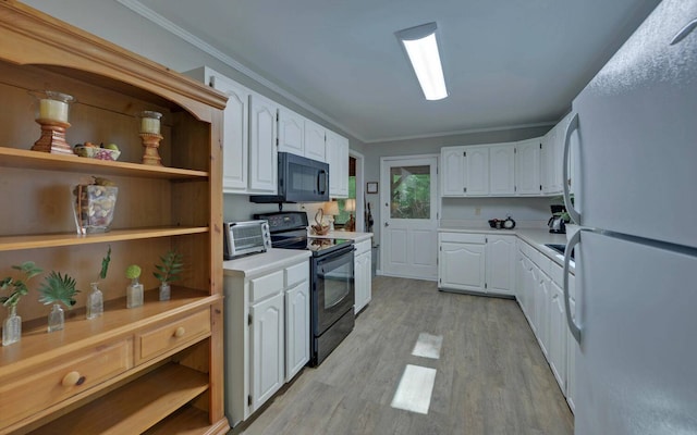 kitchen with black appliances, light hardwood / wood-style floors, white cabinetry, and ornamental molding