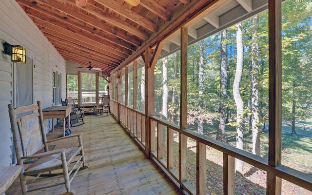 unfurnished sunroom with lofted ceiling and ceiling fan