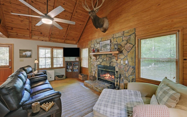 living room featuring a fireplace, wooden ceiling, beamed ceiling, ceiling fan, and high vaulted ceiling