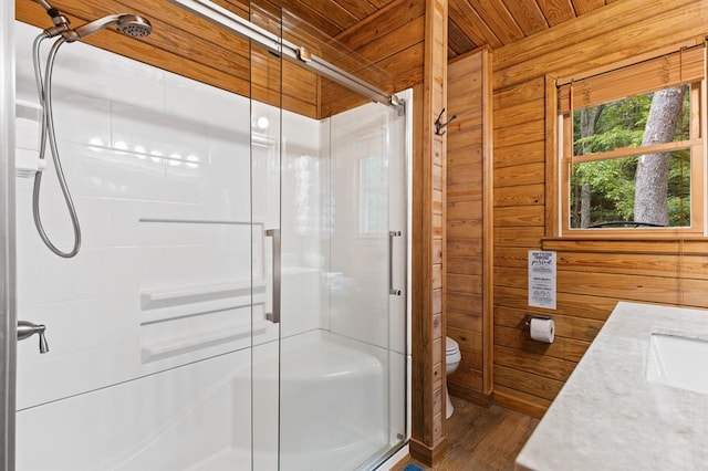 bathroom with walk in shower, toilet, wood ceiling, wood-type flooring, and wood walls