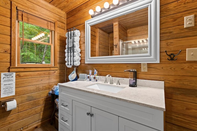 bathroom with vanity and wood walls