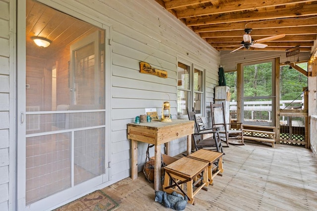 sunroom featuring ceiling fan