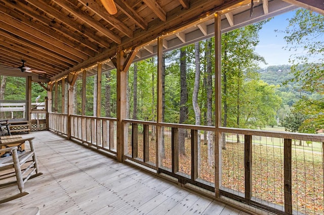 unfurnished sunroom featuring ceiling fan