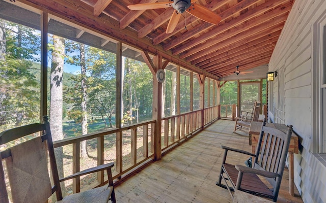 sunroom / solarium featuring ceiling fan, a wealth of natural light, wooden ceiling, and vaulted ceiling