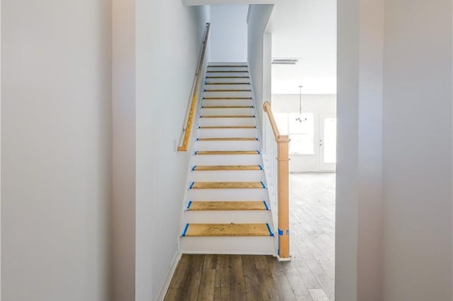 stairs with wood-type flooring and baseboards