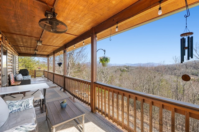 wooden deck featuring a forest view