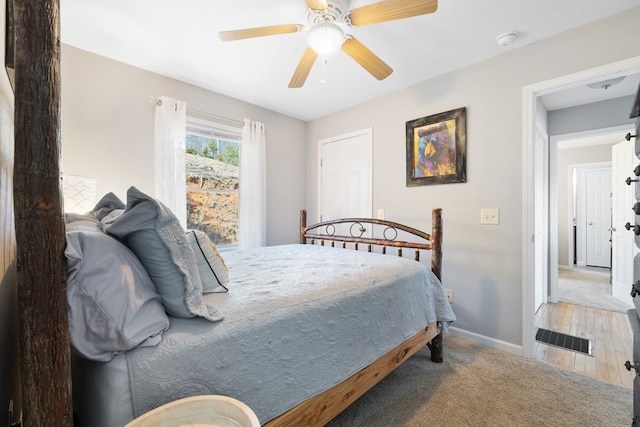 bedroom with a ceiling fan, carpet flooring, baseboards, and visible vents