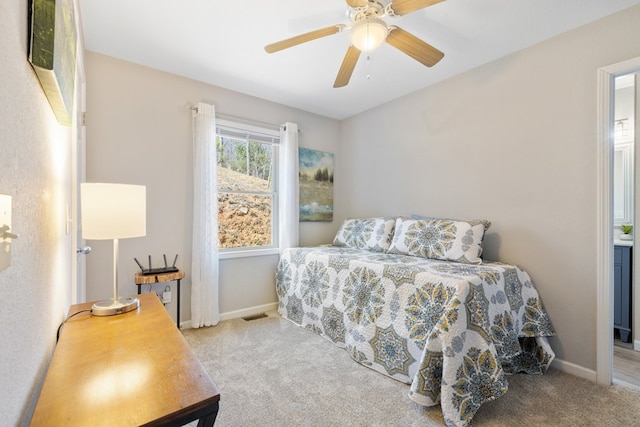 carpeted bedroom with visible vents, ceiling fan, and baseboards