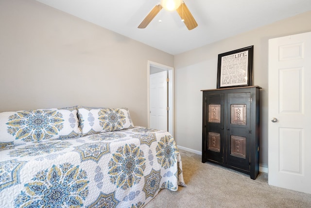 bedroom with light colored carpet, baseboards, and ceiling fan