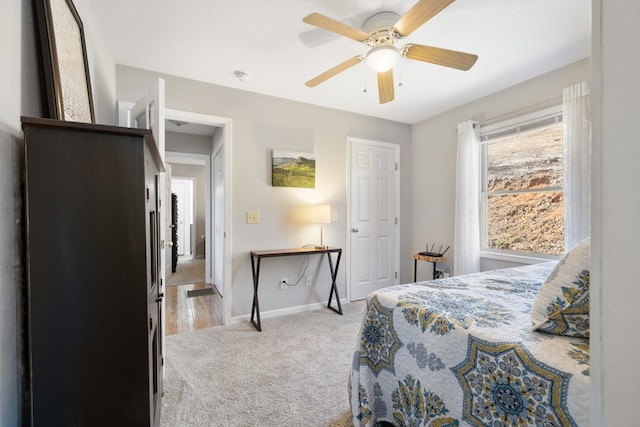 bedroom with baseboards, light colored carpet, and ceiling fan