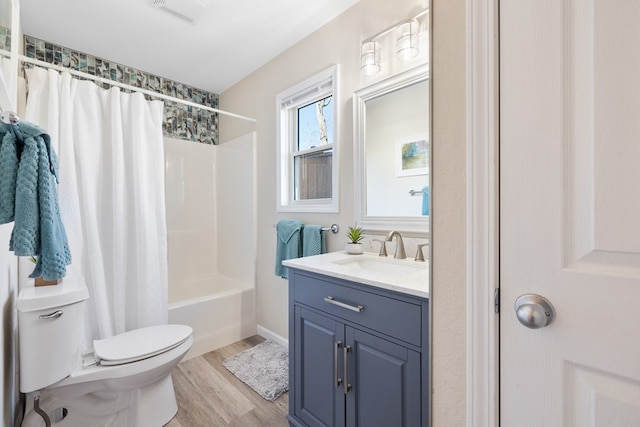 bathroom featuring vanity, wood finished floors, visible vents, shower / bath combination with curtain, and toilet