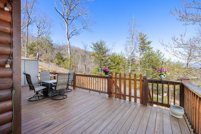 wooden terrace featuring outdoor dining space