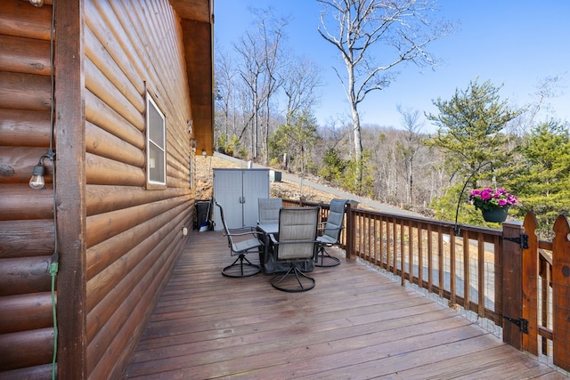 wooden deck featuring outdoor dining area