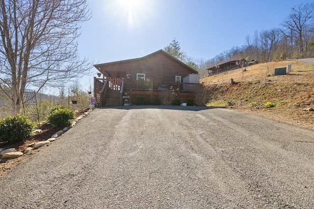 view of front of home featuring driveway and a deck