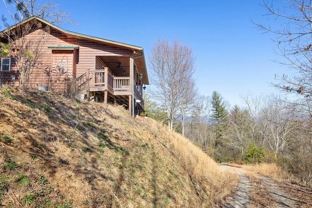 view of side of home with log veneer siding