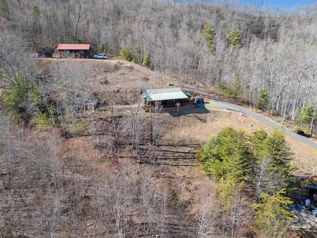 drone / aerial view with a view of trees and a rural view