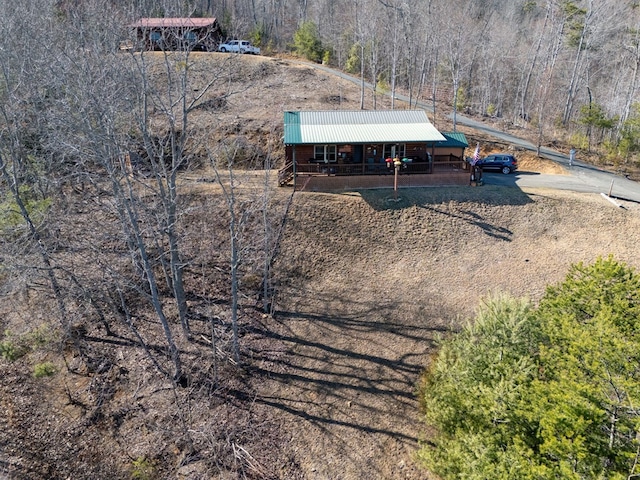 drone / aerial view with a wooded view