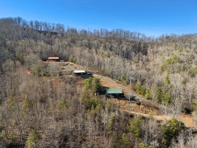 drone / aerial view with a wooded view