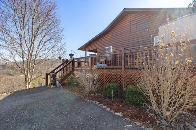 view of side of home featuring a wooden deck