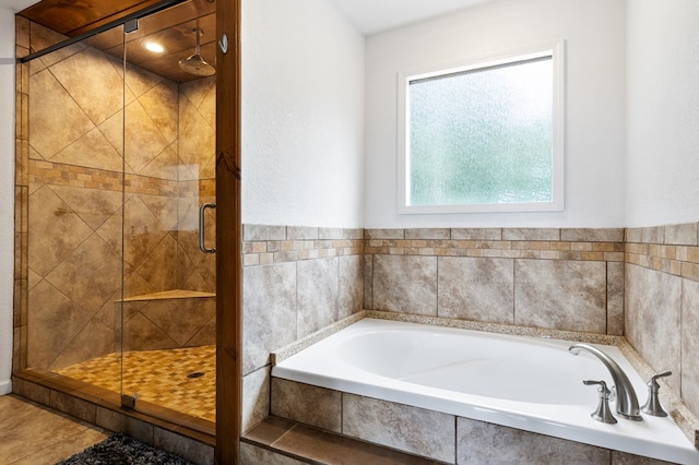 bathroom featuring separate shower and tub