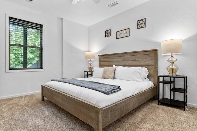 bedroom with ceiling fan and light carpet