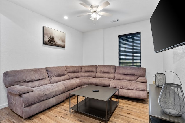 living room featuring light wood-type flooring and ceiling fan