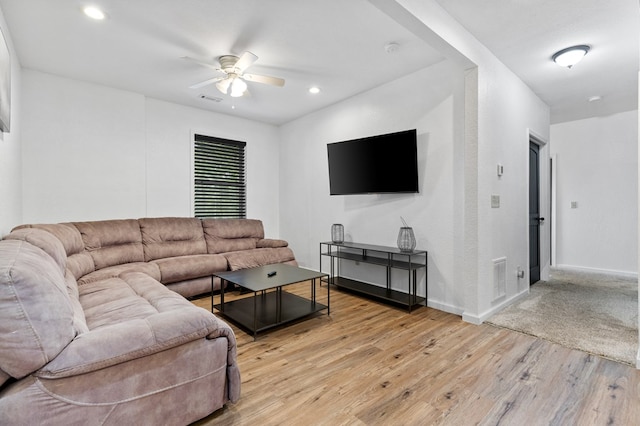 living room with ceiling fan and light hardwood / wood-style flooring