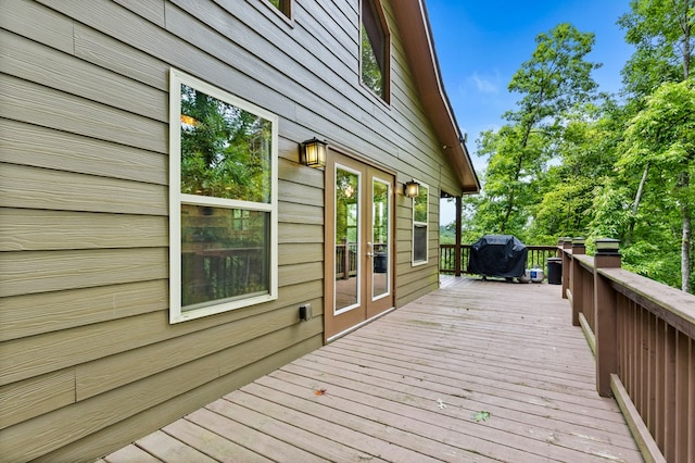 wooden terrace featuring area for grilling