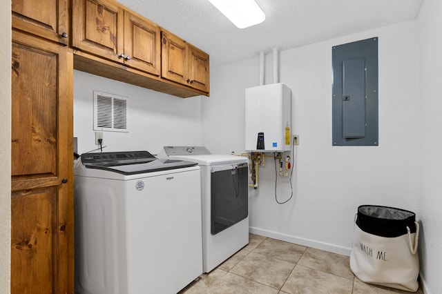 laundry room featuring cabinets, tankless water heater, washing machine and dryer, electric panel, and light tile patterned flooring