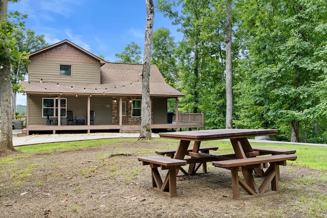 back of property featuring a wooden deck