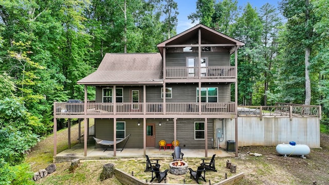 back of property featuring a patio, central AC, and an outdoor fire pit