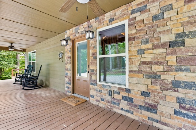 doorway to property with ceiling fan and a porch