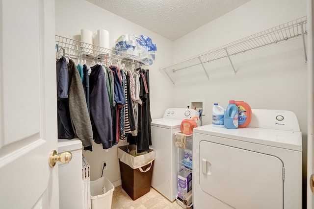 washroom featuring a textured ceiling and separate washer and dryer