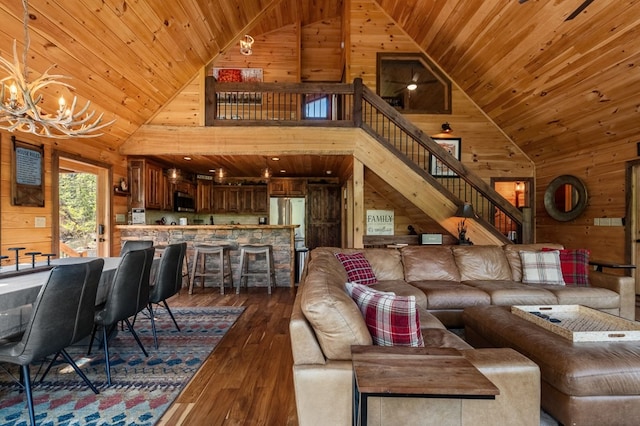 living room featuring high vaulted ceiling, wood walls, dark hardwood / wood-style floors, and wooden ceiling