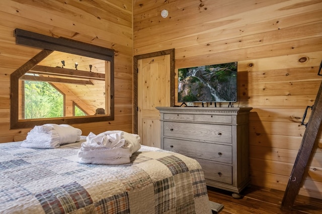 bedroom with wood-type flooring and wooden walls