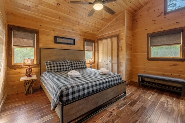 bedroom featuring wood walls, wood ceiling, hardwood / wood-style floors, and ceiling fan