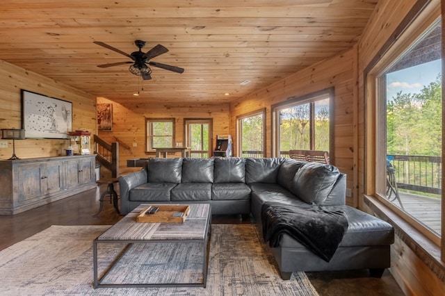 living room featuring wooden ceiling, dark hardwood / wood-style floors, wood walls, and ceiling fan